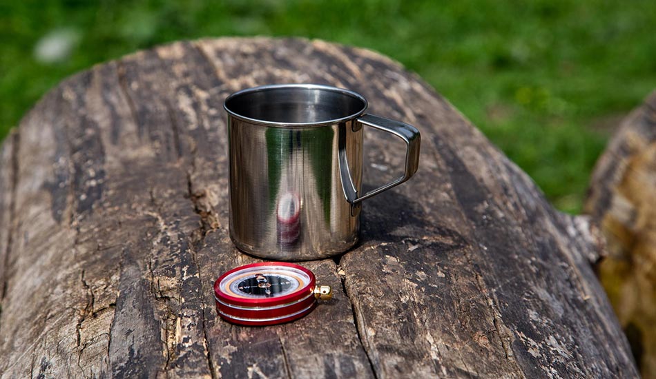 metal bushcraft cooking cup over campfire