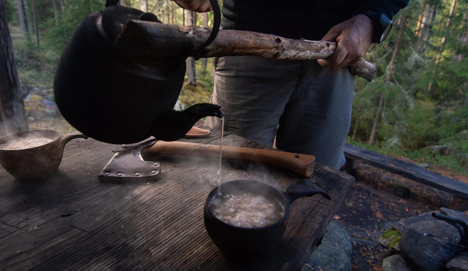 Essential bushcraft tools on a wooden surface